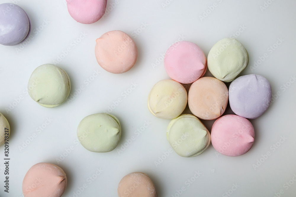 Dessert. Sweet multi-colored marshmallows on a white background Dessert. Sweet multi-colored marshmallows on a white background