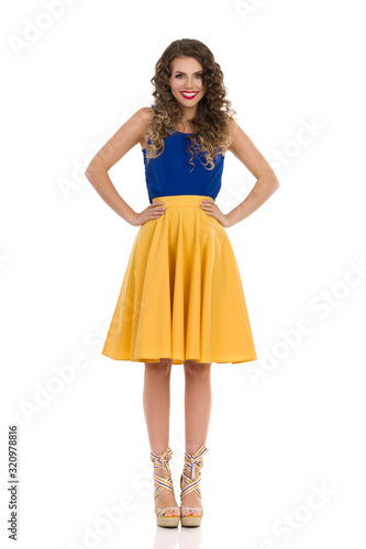 Cute Smiling Woman In Wedge Shoes And Yellow Skirt. Front View.
