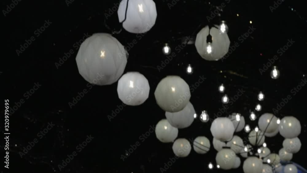 White Round Lanterns With Lights Glowing In The Dark - Close Up Shot White Round Lanterns With Lights Glowing In The Dark - Close Up Shot