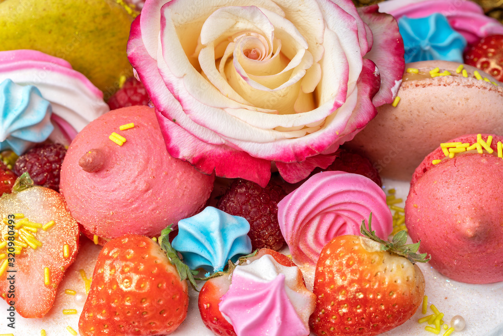 Cake of strawberries, chocolate, marshmallows, roses and sweet decorations on a close-up