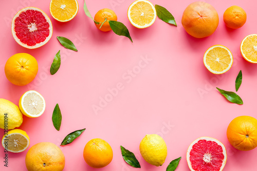 Citrus fruits - lemons, grapefruits - on pink background mockup, frame top-down copy space