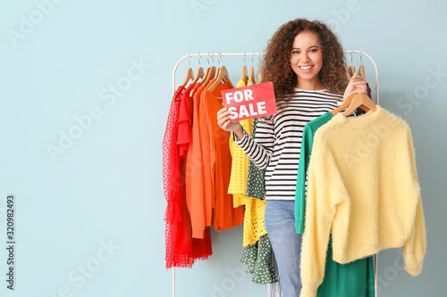 Smiling young woman holding...