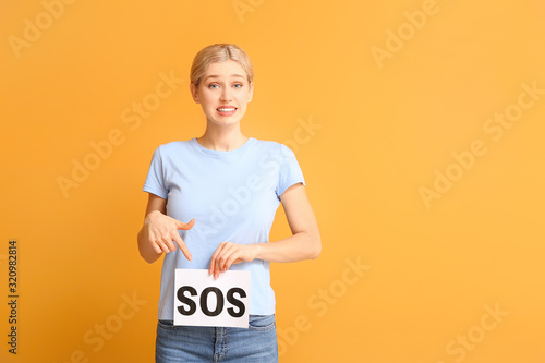 Young woman holding paper w...