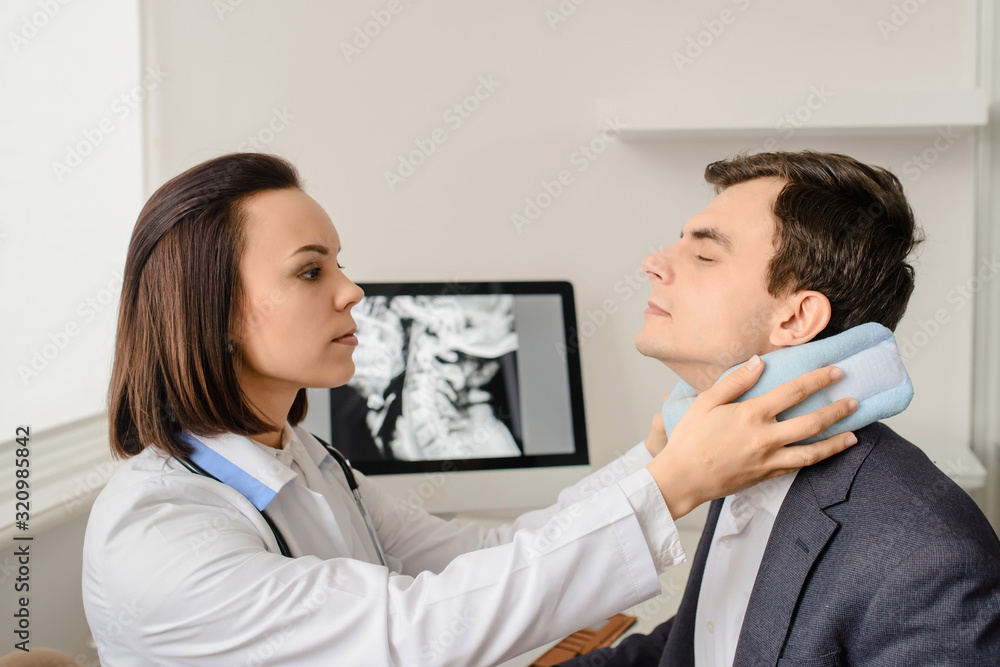 Young woman doctor apply traumatological collar Young woman doctor apply traumatological collar