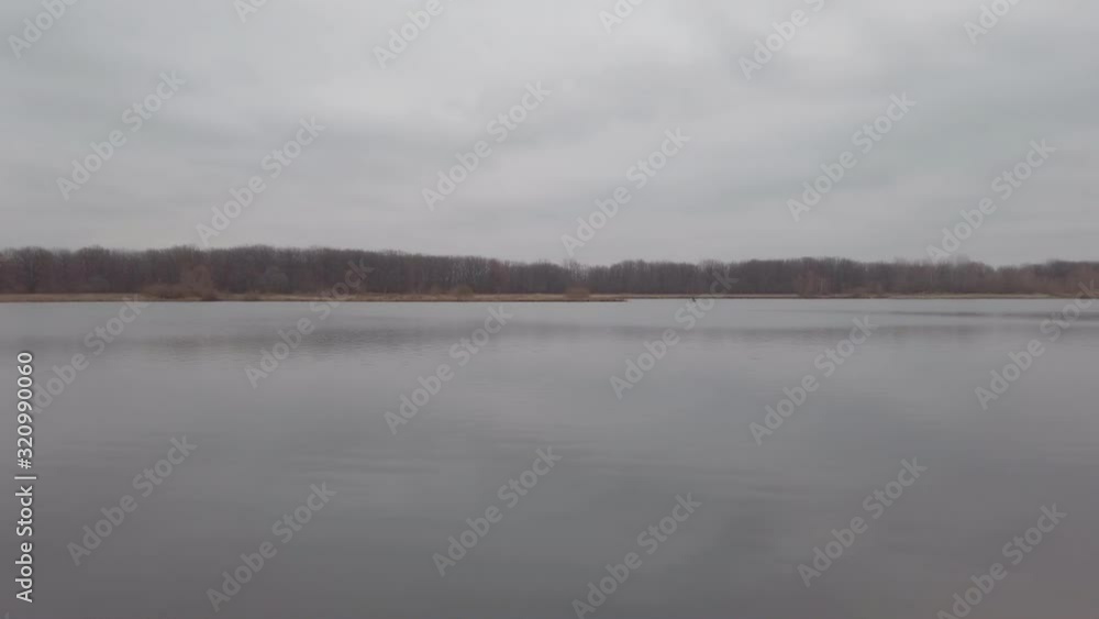 Panorama of a large lake or river on a cloudy dark autumn day Panorama of a large lake or river on a cloudy dark autumn day