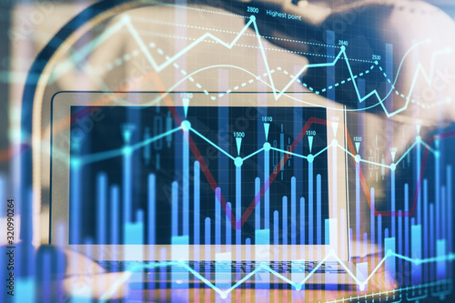 Forex market graph hologram and personal computer on background. Multi exposure. Concept of investment.