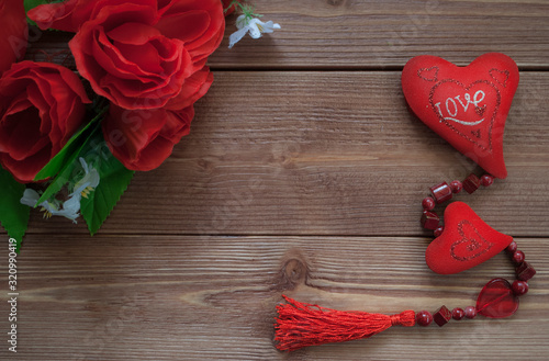 Red heart close-up on a wooden brown background