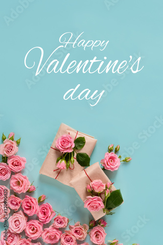Valentine's day banner.postcard favorite.Festive wreath of roses decoration with gifts and pink roses on a blue background. copyspace.flat lay © Ekaterina