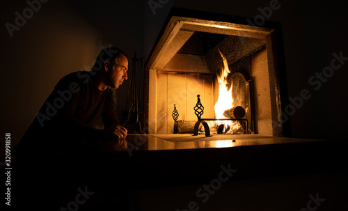 Man enjoying the heat of a burning fire in winter