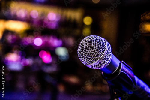 Fotografiet Comedy Music Show in a bar restaurant with a microphone and cool lighting
