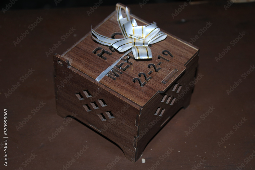 Fototapeta premium Gift box with ribbon and bow on wooden background texture