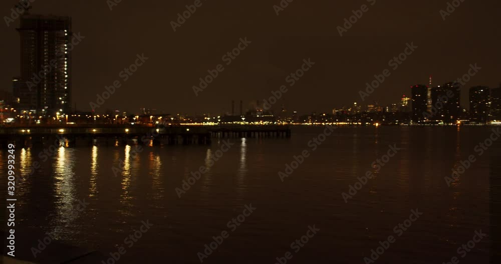 Night panning shot of the East River, overlooking Downtown Eastside of New York City. The view is from Long Island City Gantry Plaza State Park at night. Night panning shot of the East River, overlooking Downtown Eastside of New York City. The view is from Long Island City Gantry Plaza State Park at night.