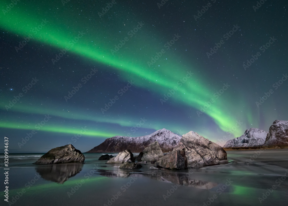 Northern lights over beach in Lofoten in Norway