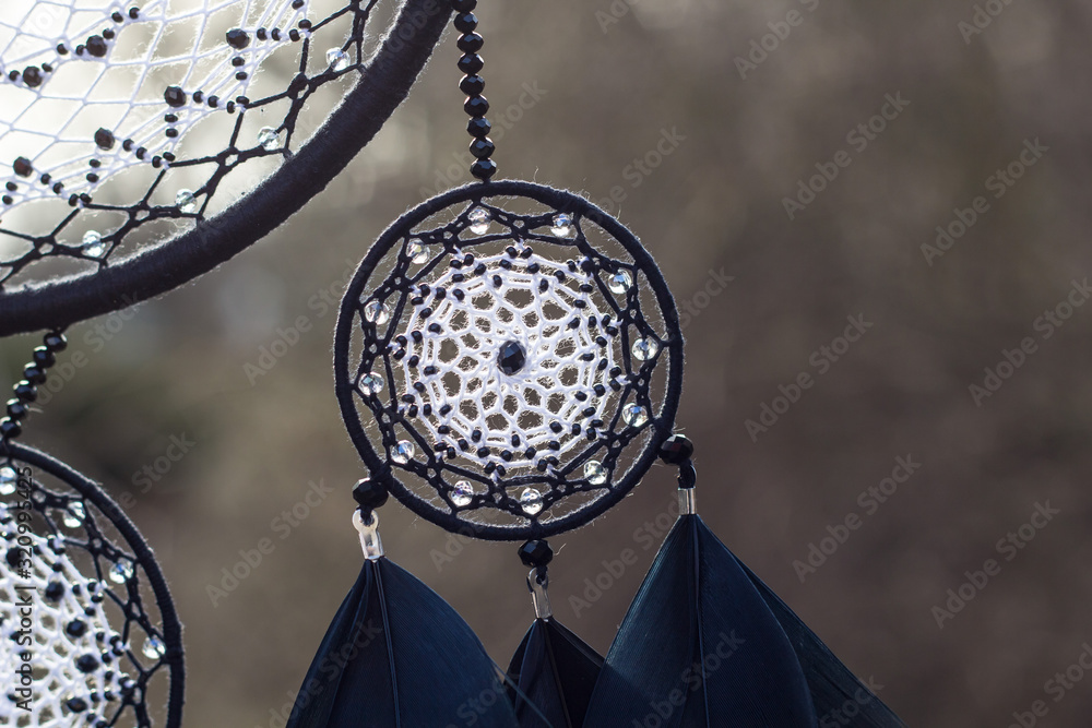 Obraz premium Handmade dream catcher with feathers threads and beads rope hanging