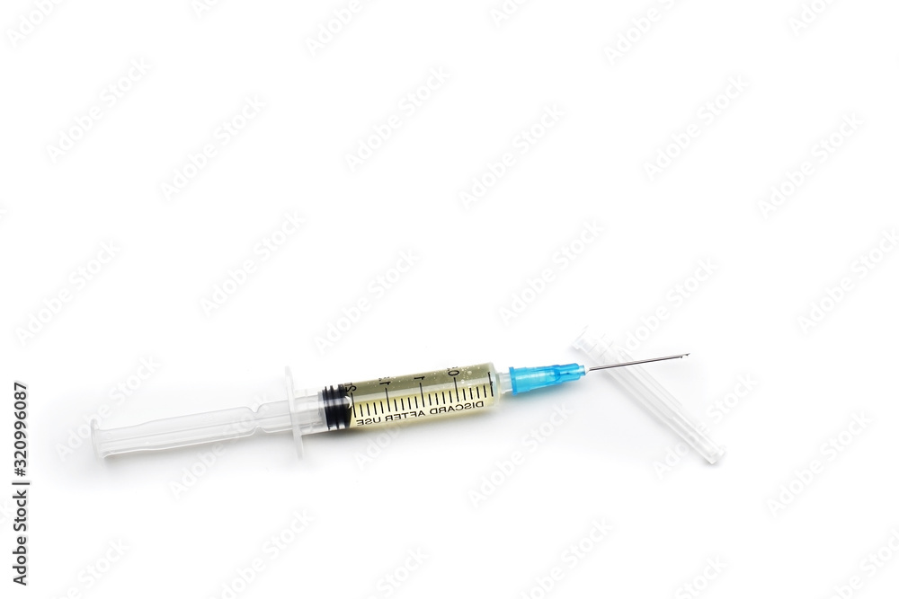 close-up of a syringe with an injection and a cap on an isolated white background.