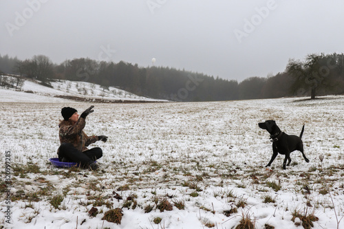 Girl throws dog snowball