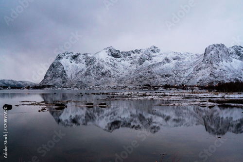 Outstanding snowy mountains reflecting in lake mirror. Winter picture of Lofoten islands  Norway.