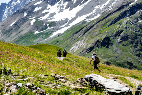 Elderly tourists walking in the mountains of the French Alps.