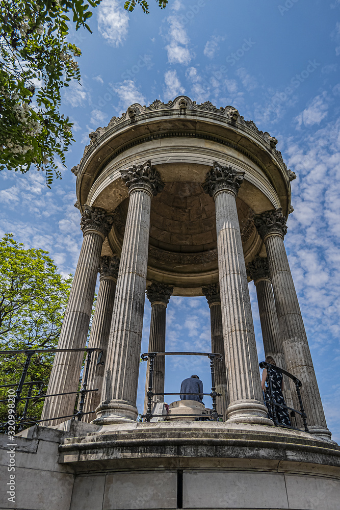 Parc des Buttes-Chaumont (1867) - Public Park in northeastern Paris. Most famous feature of park is Temple de la Sibylle (1867) - miniature version of ancient Roman Temple of Vesta. Paris, France.