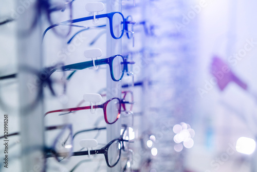 Row of glasses at an opticians. Eyeglasses shop. Stand with glasses in the store of optics.