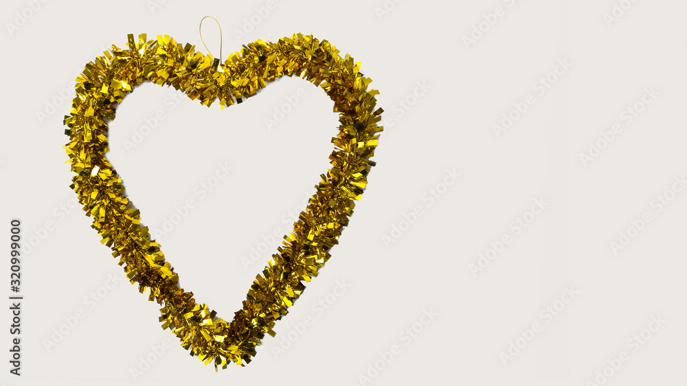 Golden heart shaped garland on a white background on Valentines day Golden heart shaped garland on a white background on Valentines day