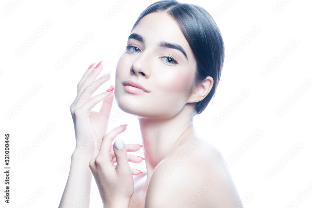 Naklejka premium Beautiful woman applying cream on her face, perfect skin, nude natural makeup. Isolated. White background. Skincare facial treatment concept