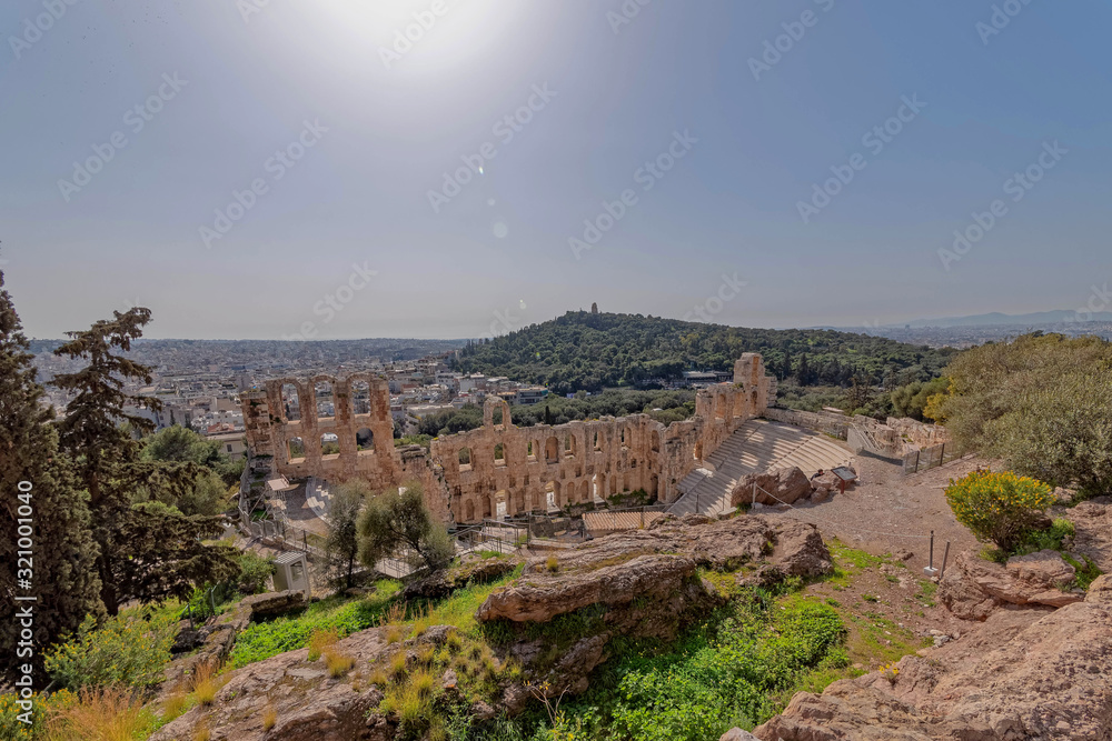 Greece, Herodium open odeon under Acropolis and Athens panoramic view under hot burning sun with light lens flare