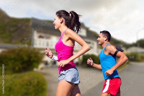Happy fitness couple of runners runing