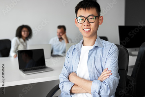 Confident Asian trainee in office photo