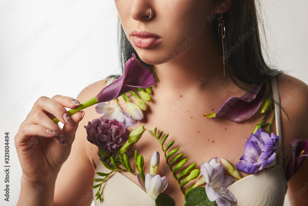 cropped view of girl in bra with violet and purple flowers on body isolated on white