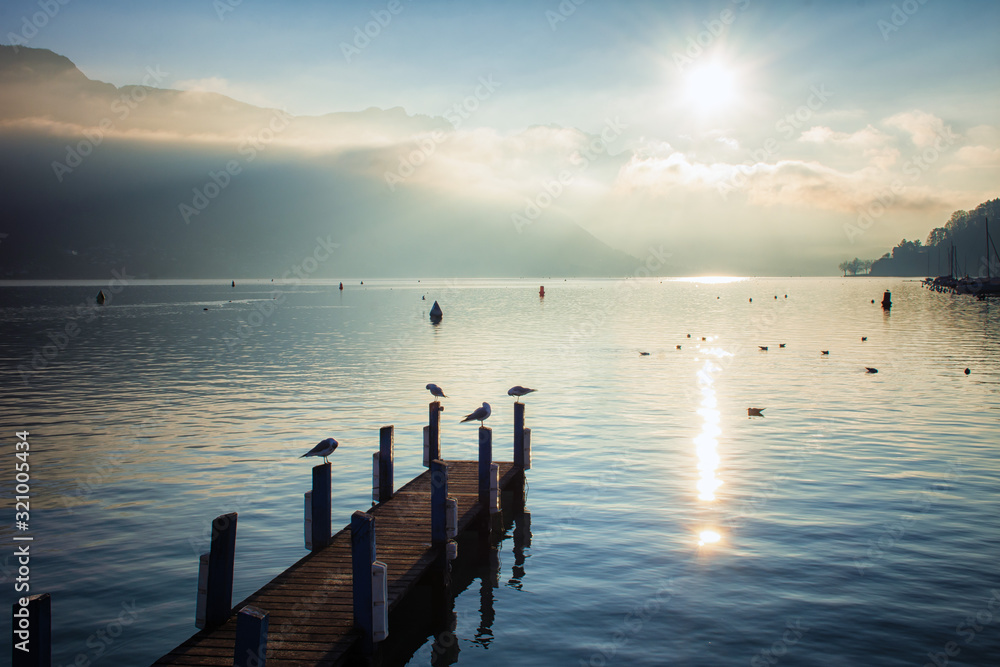 old wooden pier at sunrise by the lake old wooden pier at sunrise by the lake