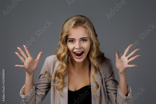 Portrait of young surprised beautiful business woman with shocked facial expression