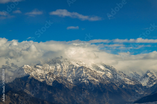 A series of himalayan mountain in garhwal range against clouds and sky