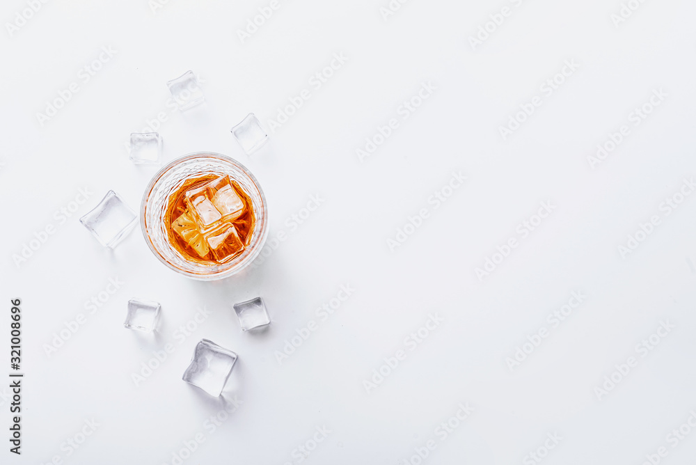 glass of whiskey with ice on a white background with place for text glass of whiskey with ice on a white background with place for text