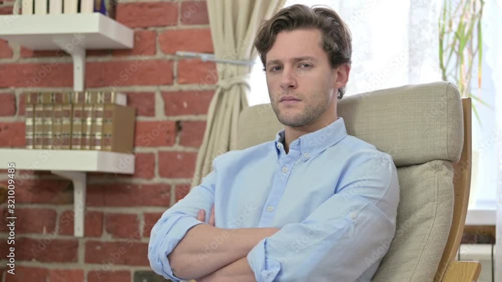 Serious Young Man Looking at Camera Serious Young Man Looking at Camera