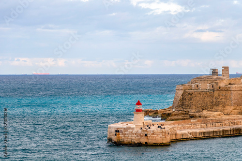 Old lighthouse and breakwater bridge of Fort Ricasoli from Valletta in Malta © nomadkate