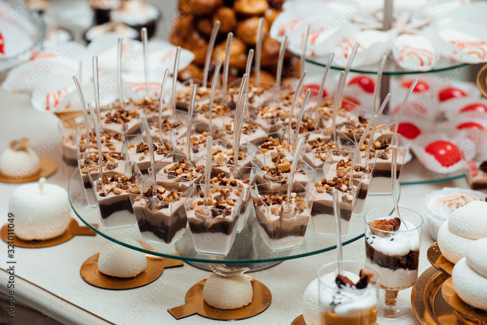 Candy bar. Table with different sweets for party. Delicious sweet buffet with cupcakes. Sweet holiday buffet with cupcakes and other desserts.