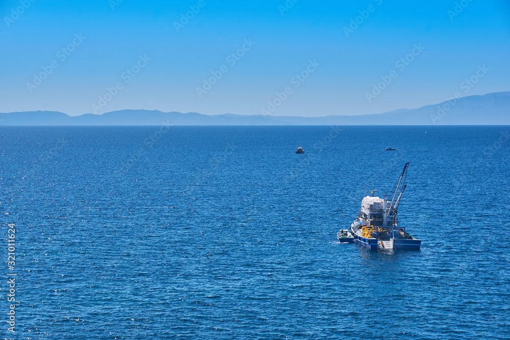Fishing boat on the water catching fish Fishing boat on the water catching fish