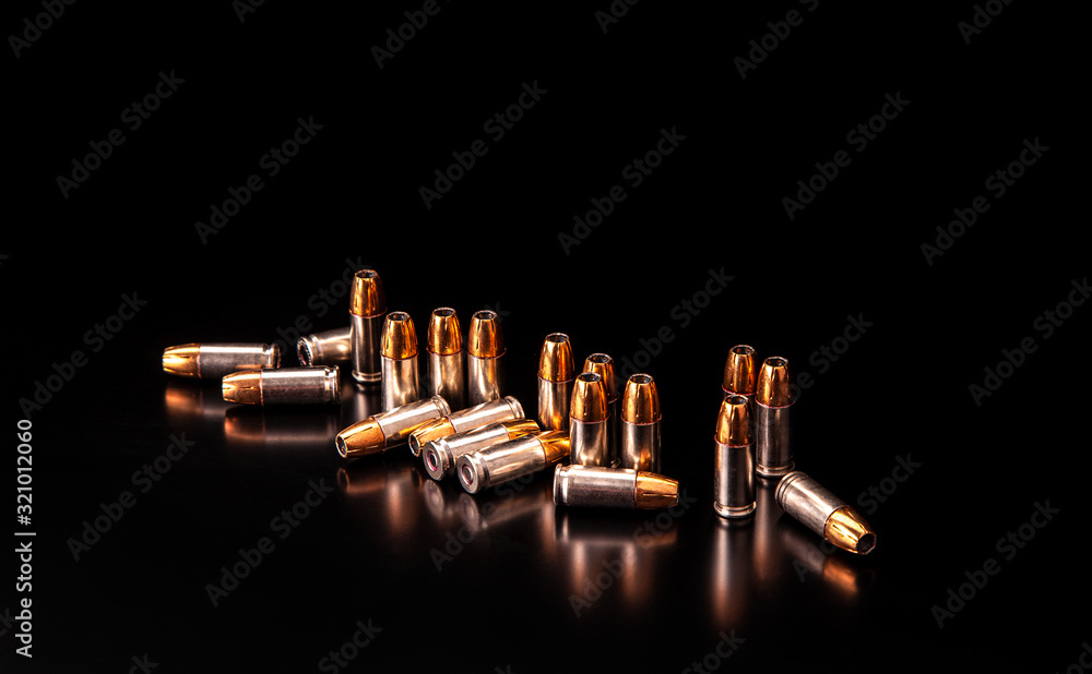 Bullet isolated on black background with reflexion. Rifle bullets close-up on black back. Cartridges for rifle and carbine on a black. Bullet isolated on black background with reflexion. Rifle bullets close-up on black back. Cartridges for rifle and carbine on a black.