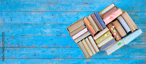 Multicolored books, flat lay, panorama format with free copy space. Reading, education, literature, learning, book fair concept