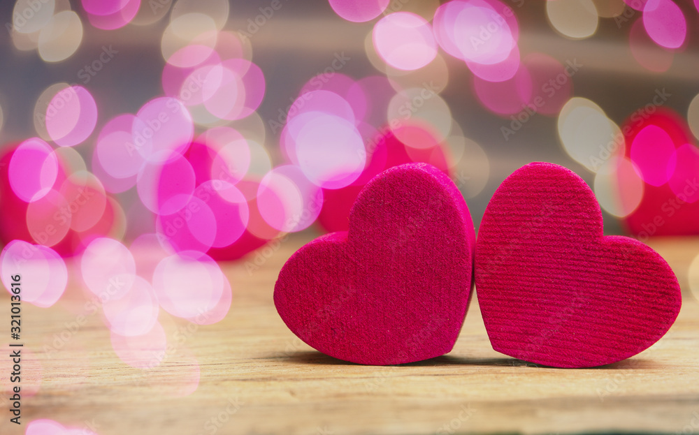 Small wooden hearts with pink bokeh effects Small wooden hearts with pink bokeh effects