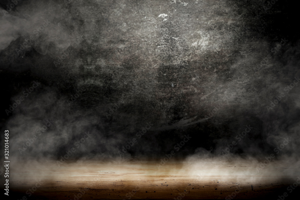 Desk of free space and black background with smoke decoration. 