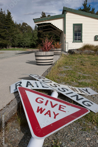 Highlands near Garston. Valley. Railroad and trainstation. At Fairlight Traffic signs. Give way. photo