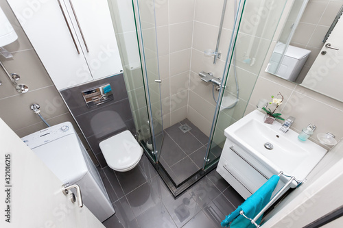 Interior of small modern bathroom with shower