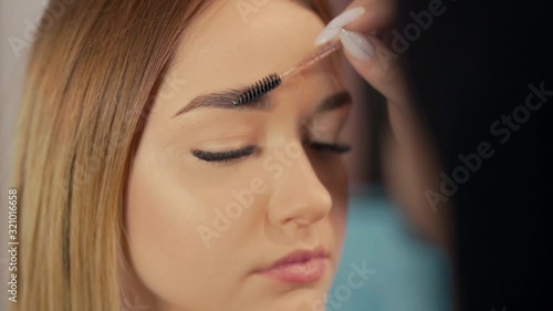 Wallpaper Mural beautiful girl in salon draws eyebrows with a brush Torontodigital.ca