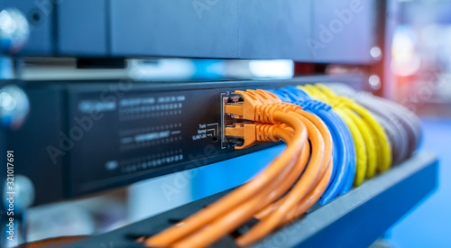 Fotografie network cable connecting on network core switch close up