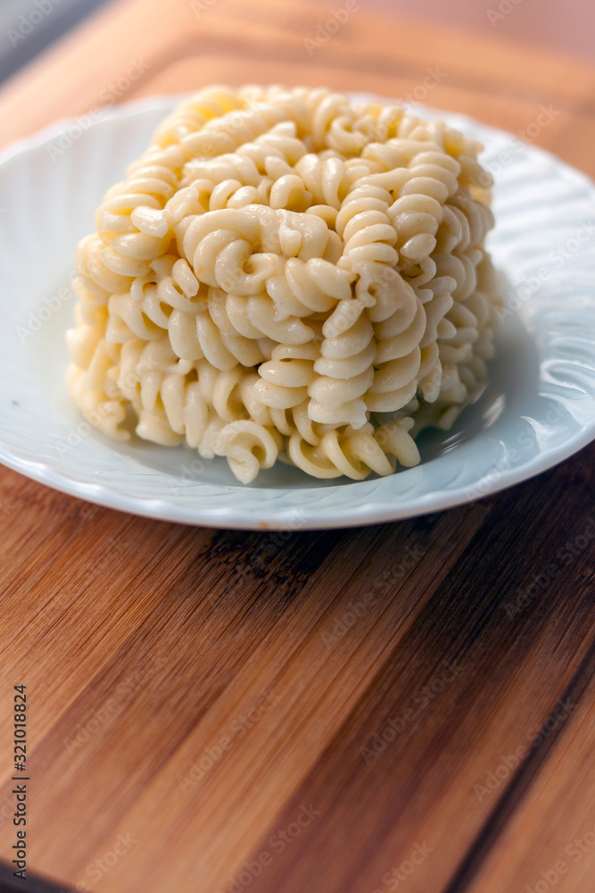 cube block shaped Leftover Cooked Pasta in the plate cube block shaped Leftover Cooked Pasta in the plate