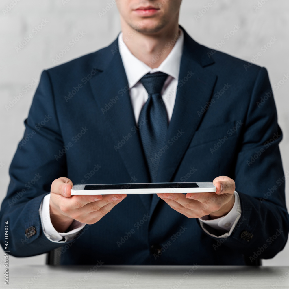 cropped view of realtor holding digital tablet on white cropped view of realtor holding digital tablet on white