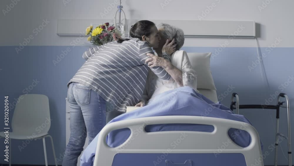 Woman visiting her senior mother at the hospital Woman visiting her senior mother at the hospital