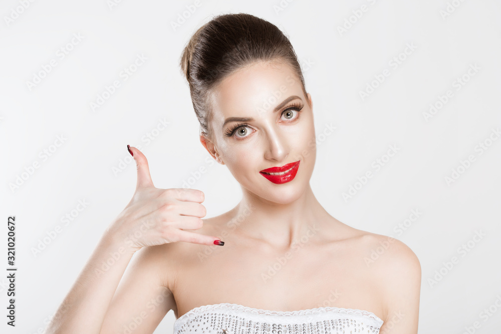 Naklejka premium Closeup portrait headshot young single woman excited happy student making showing call me gesture sign with hand shaped like phone isolated white wall background Positive human emotion face expression